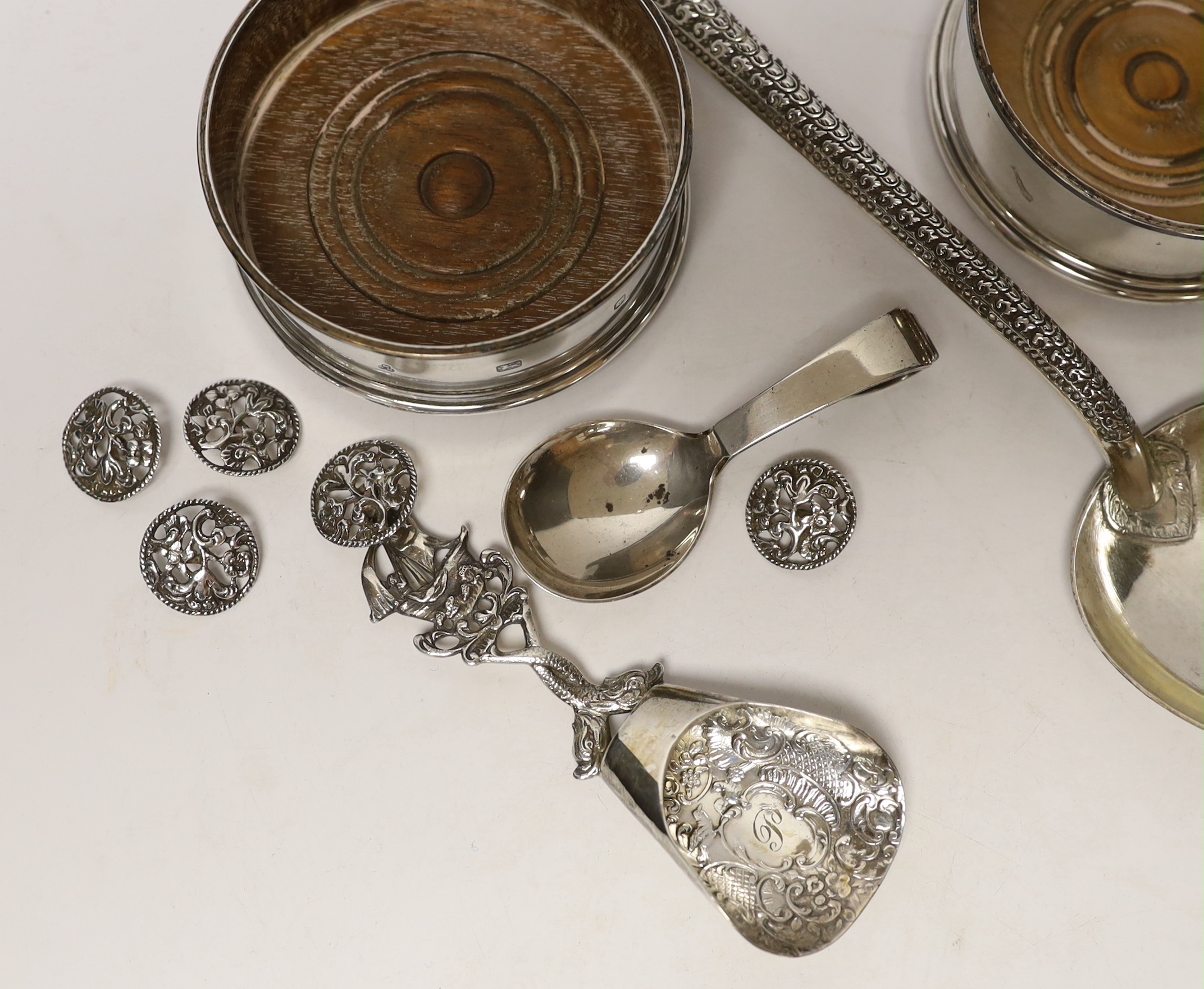 A Georg Jensen silver christening spoon, a pair of modern silver wine coasters, a set of five silver buttons and two white metal spoons, one stamped 800.